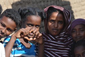 Young dark skinned children one girl making a heart with her hands
